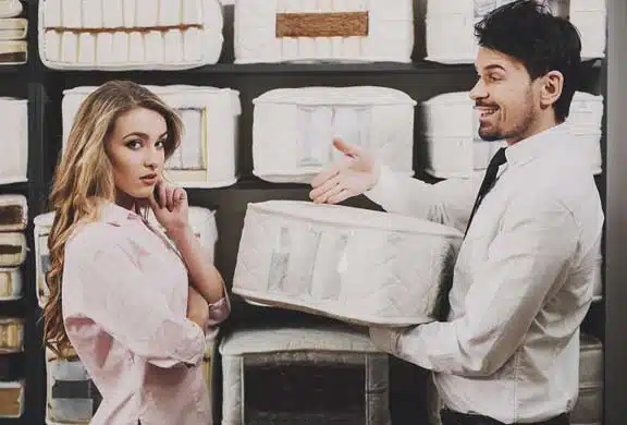 Salesman Explaining Mattress Features