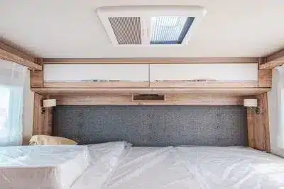 Modern RV bedroom with grey headboard