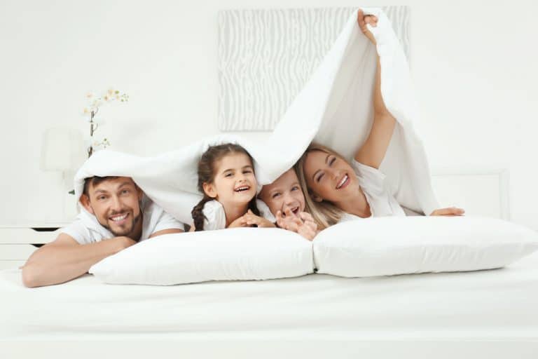 family of four in bed