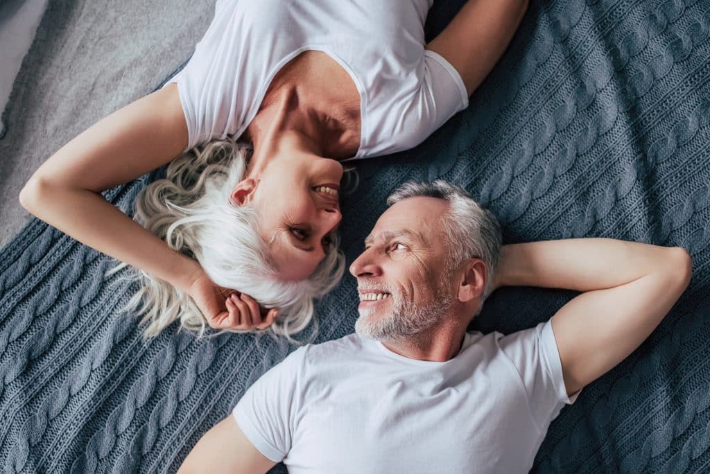 Couple relaxing on comfortable mattress
