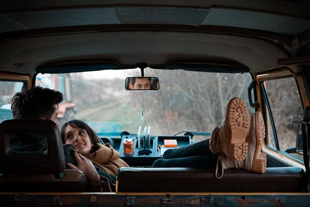 Couple relaxing in transit van mattress