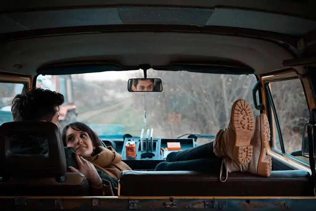 Couple relaxing in transit van mattress