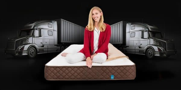 Lady sitting on the Park Meadow in front of a truck