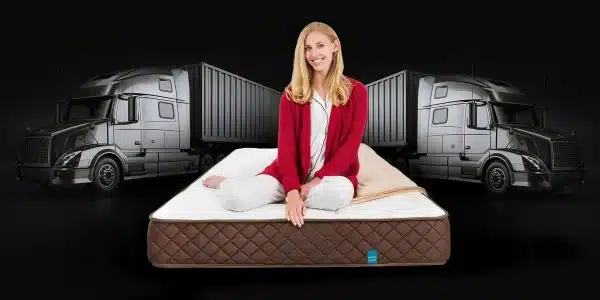 Lady sitting on the Park Meadow in front of a truck