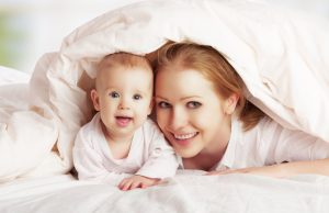 Mother and baby co-sleeping in bed