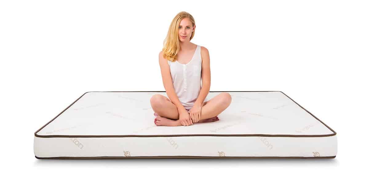 Elation Mattress with Model Sitting on Top